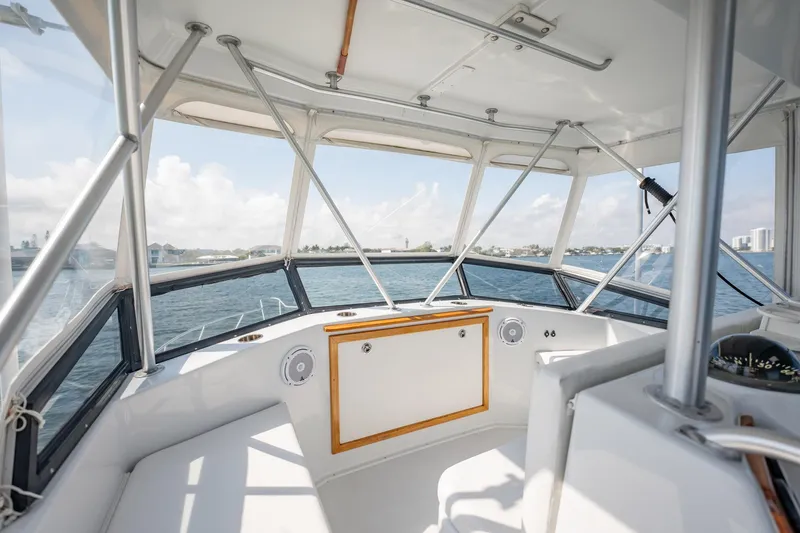 Slide: The Image of 1991 Jersey 42 Convertible Sportfisherman interior with ocean view, featuring helm and seating area. - 41