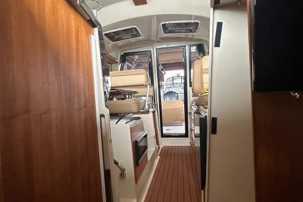 Slide: The Image of Interior of 2021 Ranger Tugs R-27 boat with wood finishes and modern amenities. - 7