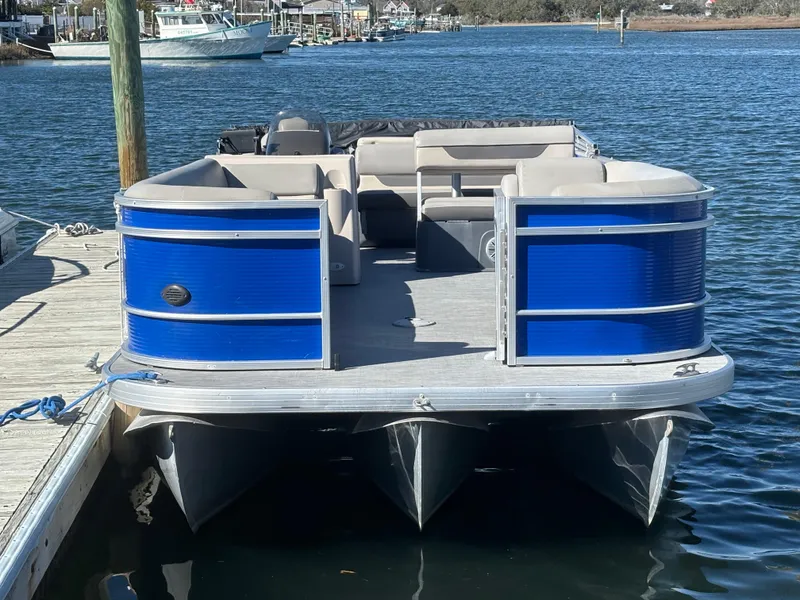 Slide: The Image of 2022 Princecraft Vectra 23 pontoon boat docked on calm water. - 1
