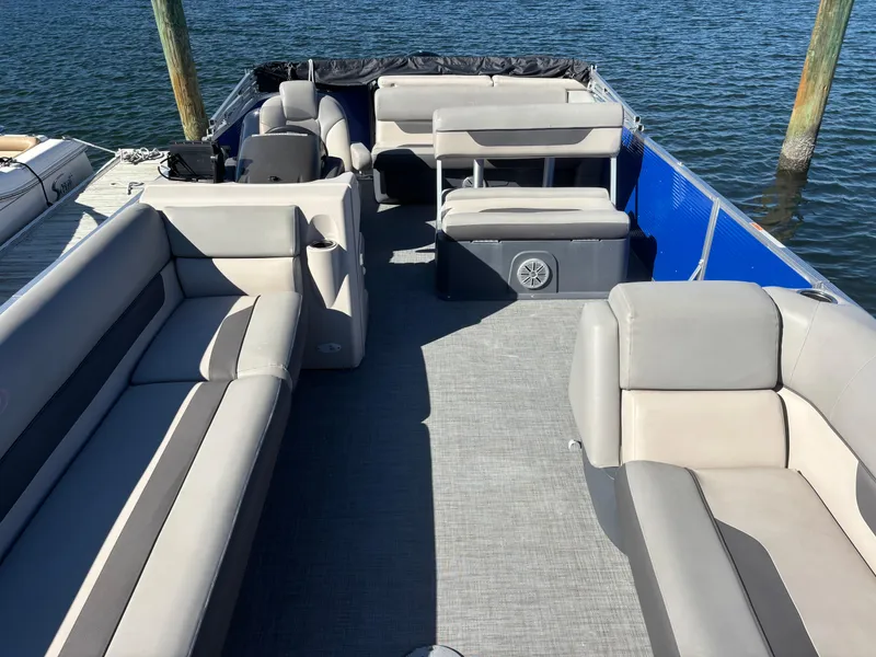Slide: The Image of 2022 Princecraft Vectra 23 pontoon boat with spacious seating on a calm lake. - 10
