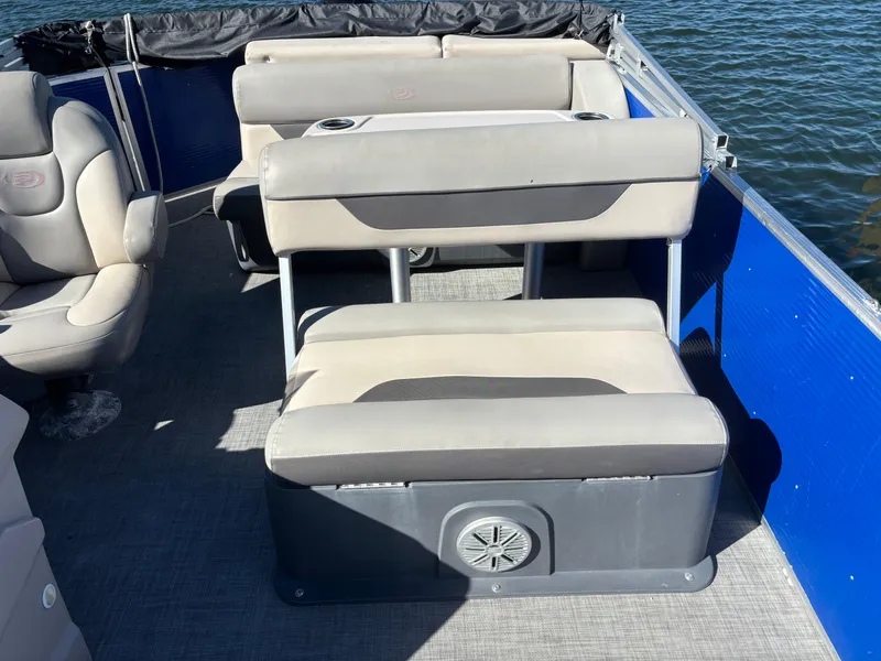 Slide: The Image of 2022 Princecraft Vectra 23 pontoon boat interior with beige seating and blue side panels. - 11