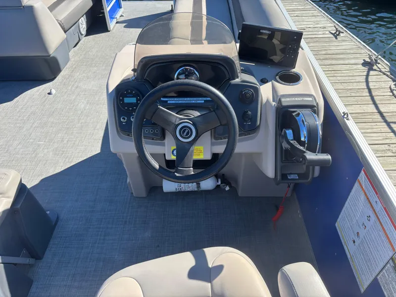 Slide: The Image of 2022 Princecraft Vectra 23 boat dashboard with steering wheel and controls. - 13