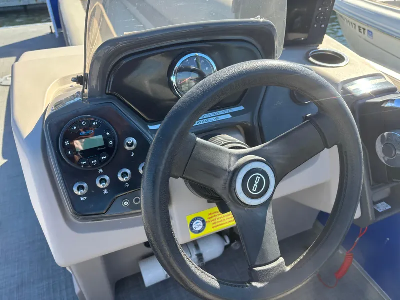 Slide: The Image of 2022 Princecraft Vectra 23 boat dashboard with steering wheel and control panel. - 14