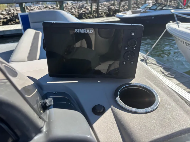 Slide: The Image of Simrad display on 2022 Princecraft Vectra 23 boat dashboard, docked by water. - 15