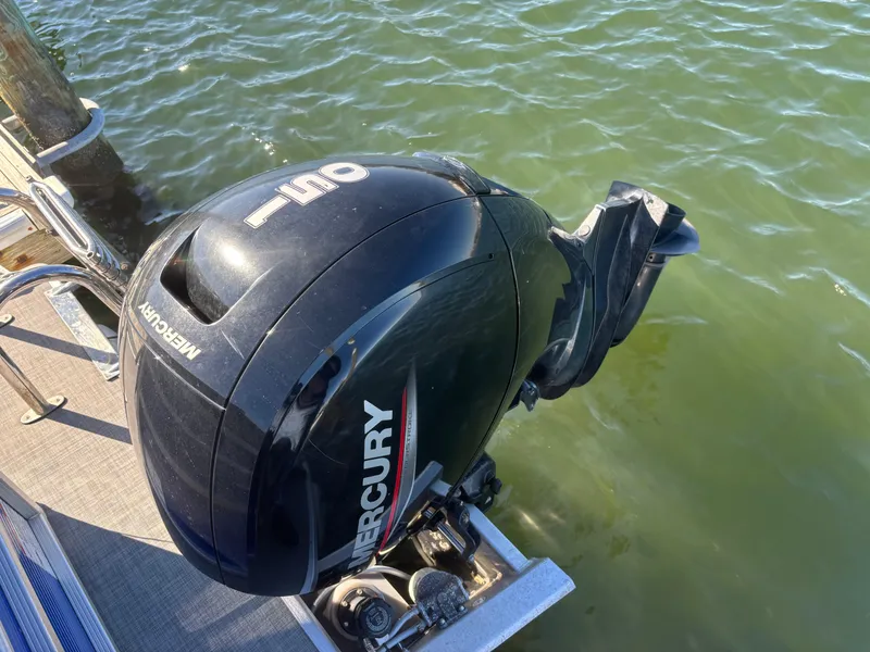 Slide: The Image of Mercury outboard motor on 2022 Princecraft Vectra 23 boat, docked by green water. - 21
