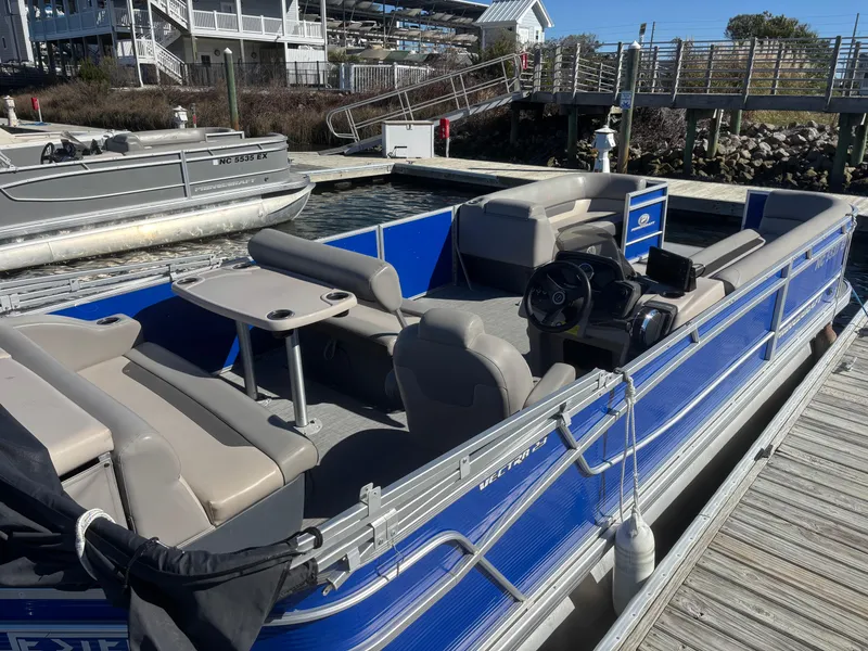 Slide: The Image of 2022 Princecraft Vectra 23 pontoon boat docked, featuring blue exterior and spacious seating. - 3