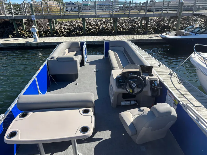 Slide: The Image of 2022 Princecraft Vectra 23 pontoon boat docked, featuring spacious seating and modern controls. - 6