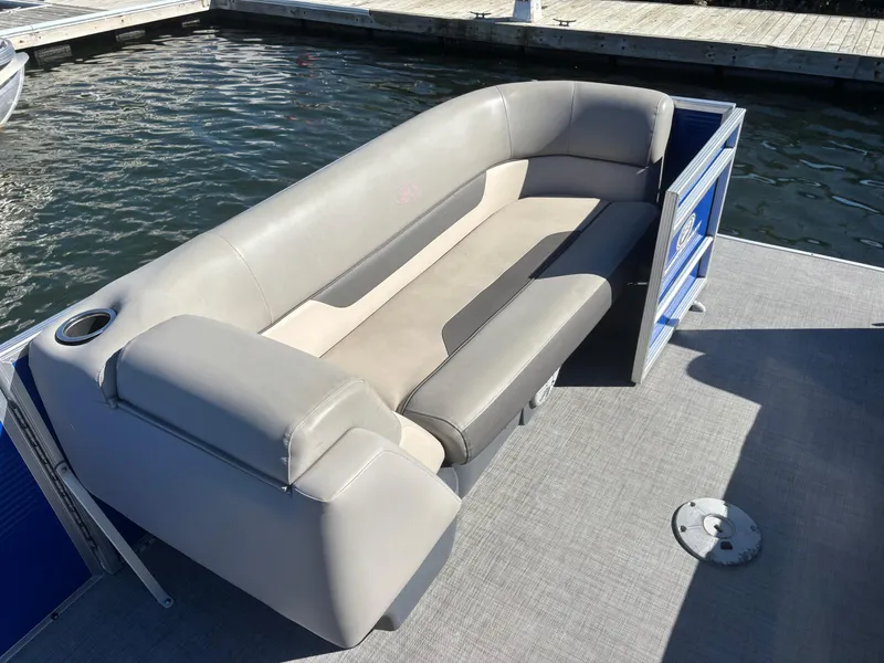 Slide: The Image of 2022 Princecraft Vectra 23 boat with gray seating, docked on calm water. - 8