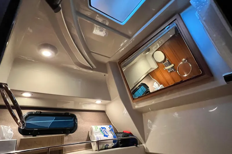 Slide: The Image of Interior of 2020 Ranger Tugs 27 boat, featuring a compact bathroom with modern fixtures. - 17