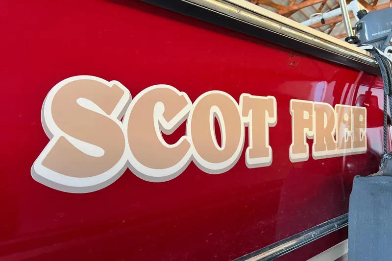 Slide: The Image of Red 2020 Ranger Tugs 27 boat with "Scot Free" lettering on the side. - 21