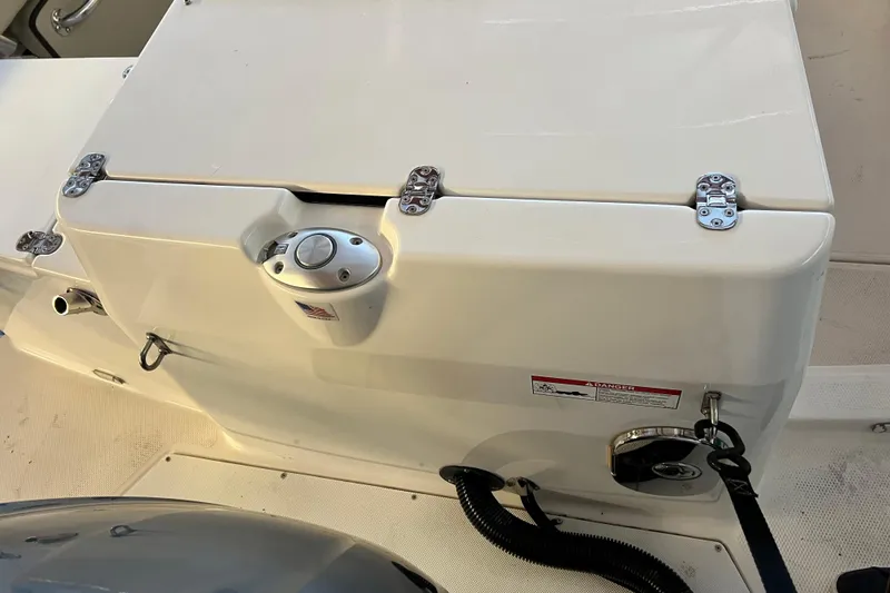 Slide: The Image of Ranger Tugs 27 (2020) boat engine compartment with secure latches and warning label. - 4