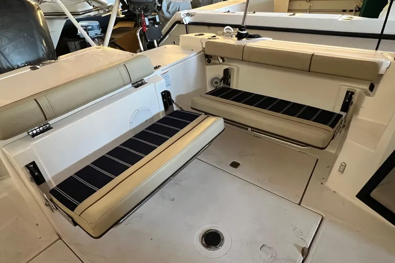 Slide: The Image of 2020 Ranger Tugs 27 boat interior with foldable seating and striped cushions. - 5
