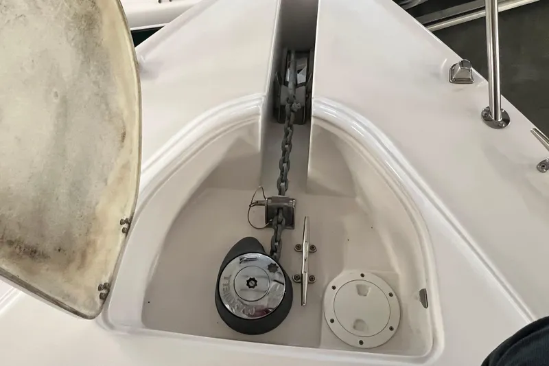 Slide: The Image of Anchor compartment of 2008 Four Winns V378 boat, featuring chain and winch. - 10