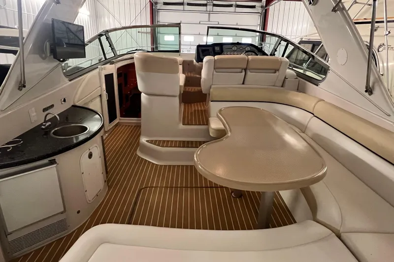 Slide: The Image of 2008 Four Winns V378 yacht interior with seating, table, and kitchenette. - 14