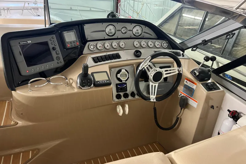 Slide: The Image of 2008 Four Winns V378 boat helm with steering wheel, gauges, and navigation equipment. - 16