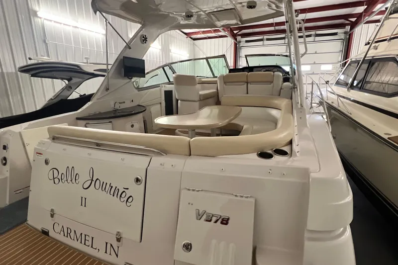 Slide: The Image of 2008 Four Winns V378 yacht interior with seating and table, docked in a storage facility. - 17