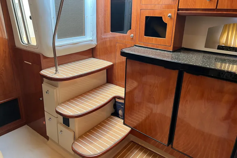 Slide: The Image of Interior of 2008 Four Winns V378 yacht with wooden stairs and cabinetry. - 24