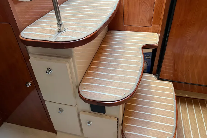 Slide: The Image of Interior steps of 2008 Four Winns V378 boat with wood finish and storage compartments. - 29
