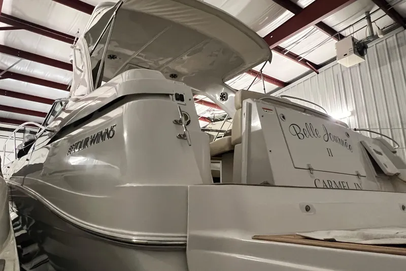 Slide: The Image of 2008 Four Winns V378 yacht in storage, rear view with "Belle Journée II" name. - 3