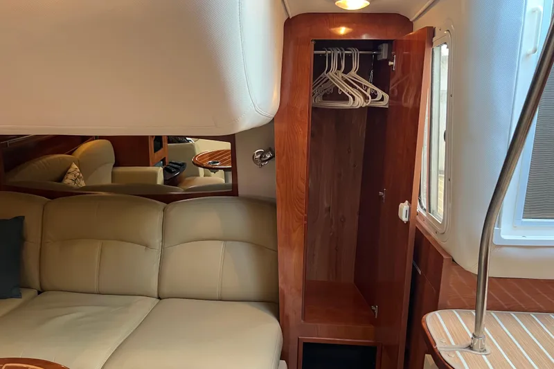 Slide: The Image of Interior of 2008 Four Winns V378 yacht with beige seating and wooden closet. - 30