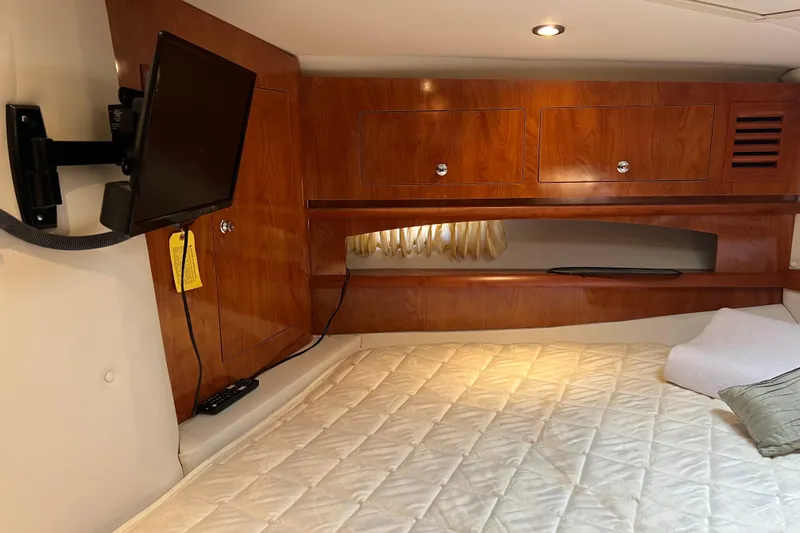 Slide: The Image of Interior cabin of 2008 Four Winns V378 with wood paneling and mounted TV. - 34
