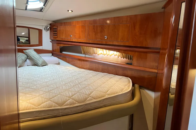 Slide: The Image of Luxurious cabin interior of 2008 Four Winns V378 yacht with wood finish and cozy bedding. - 37