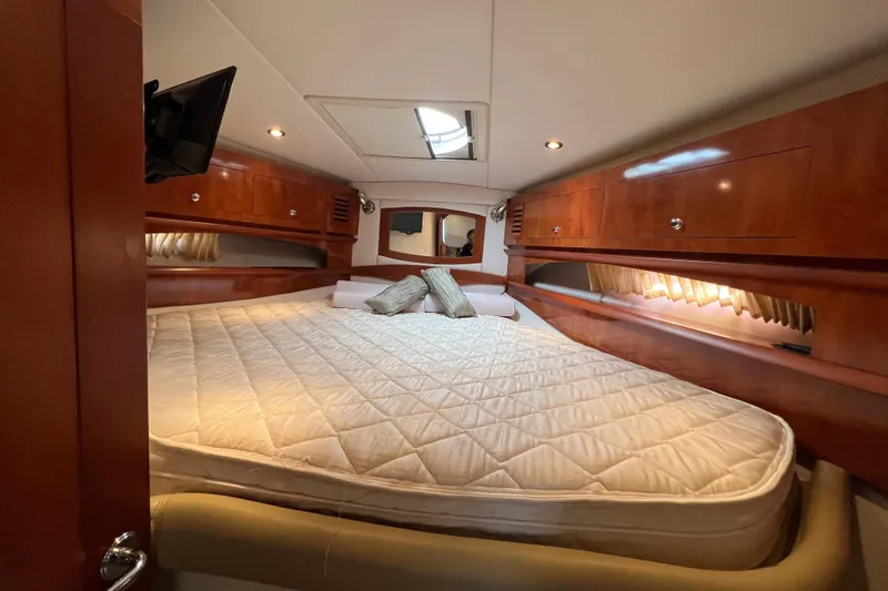Slide: The Image of Luxurious cabin interior of 2008 Four Winns V378 yacht with cozy bed and wooden cabinetry. - 38
