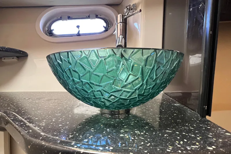 Slide: The Image of Green glass vessel sink on a speckled countertop in a 2008 Four Winns V378 boat. - 39