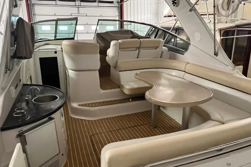 Slide: The Image of 2008 Four Winns V378 yacht interior with seating, table, and kitchenette. - 6