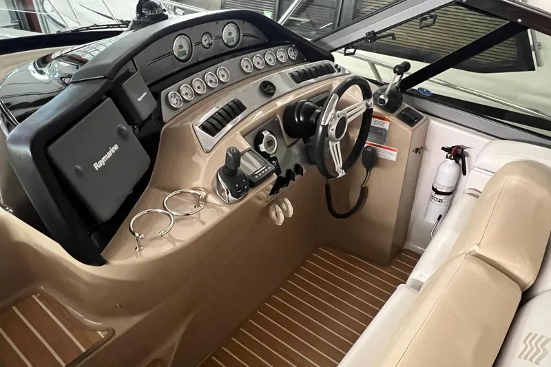 Slide: The Image of 2008 Four Winns V378 boat cockpit with steering wheel, gauges, and navigation equipment. - 7