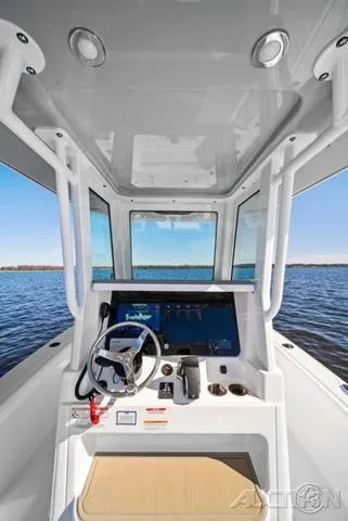 Slide: The Image of 2025 Blackfin 262 HB boat helm with modern controls and panoramic water view. - 11