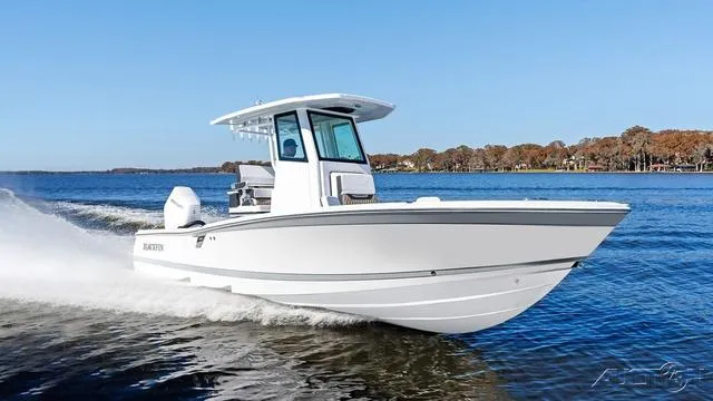 Slide: The Image of 2025 Blackfin 262 HB boat cruising on a serene lake under a clear blue sky. - 18