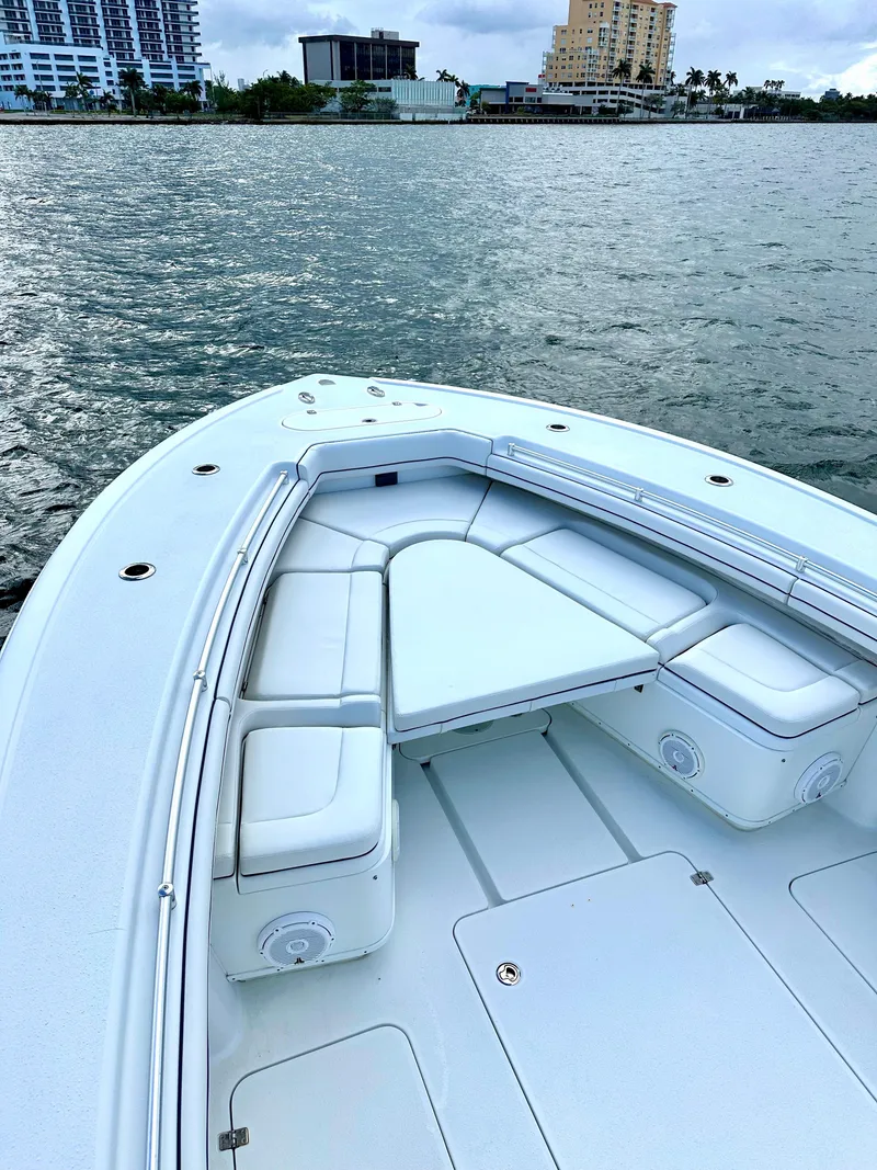 Slide: The Image of 2017 Yellowfin 39 Offshore boat with spacious seating, docked near urban waterfront. - 12