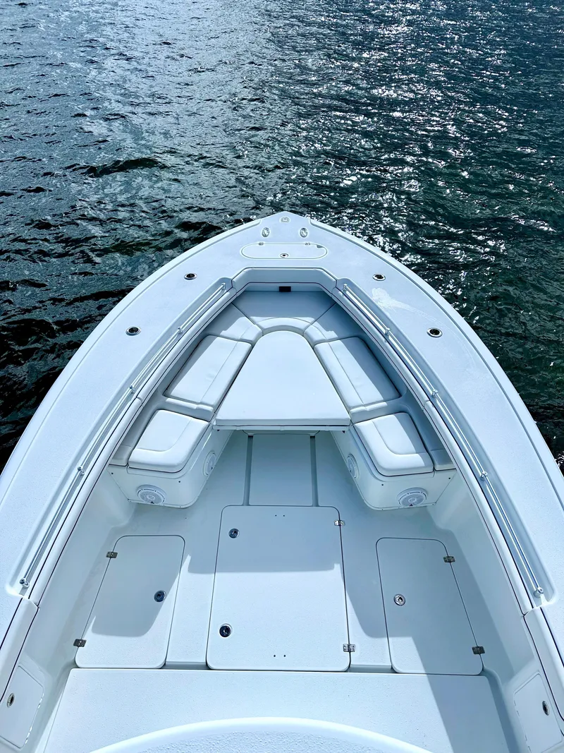 Slide: The Image of 2017 Yellowfin 39 Offshore boat on water, showcasing spacious deck and seating. - 13