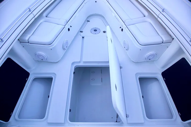 Slide: The Image of 2017 Yellowfin 39 Offshore boat interior with open storage compartments and cushioned seating. - 15