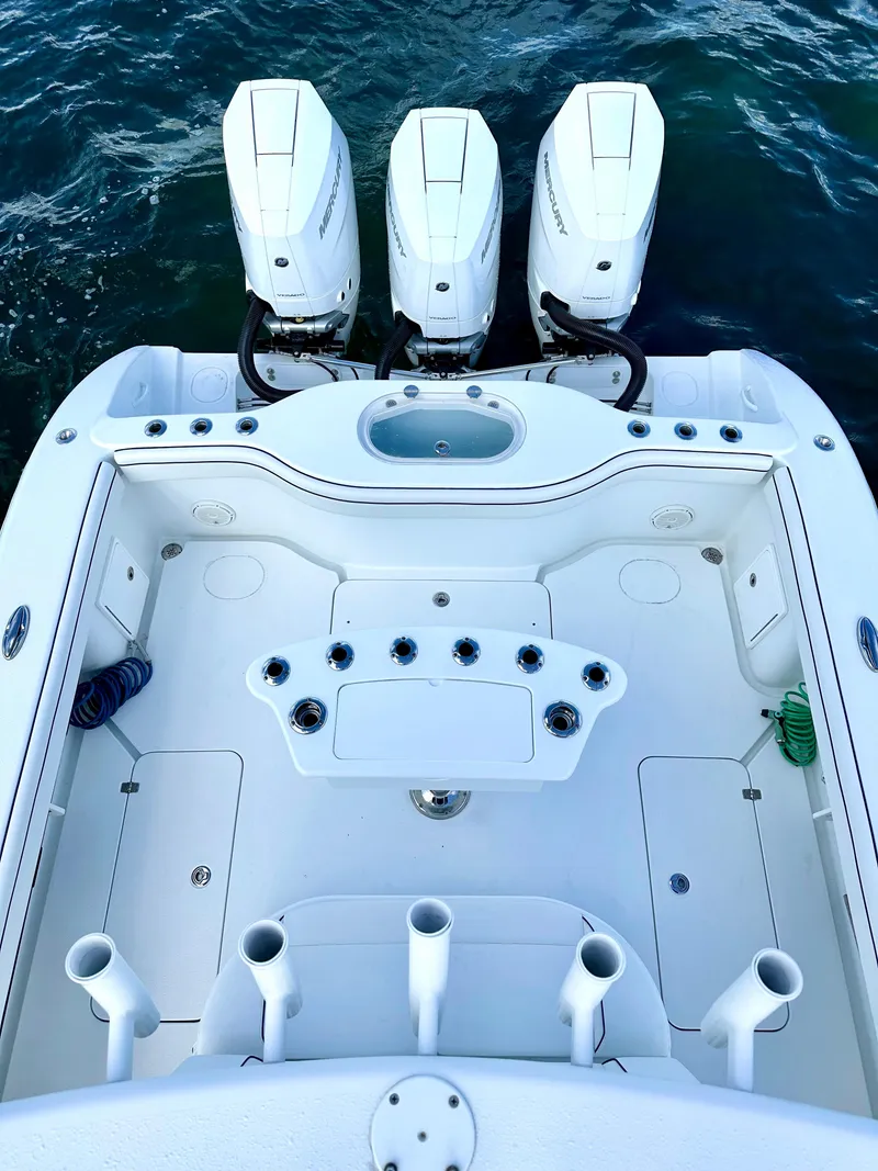 Slide: The Image of 2017 Yellowfin 39 Offshore boat with triple outboard engines on water. - 17