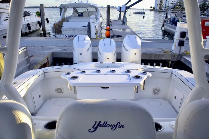Slide: The Image of 2017 Yellowfin 39 Offshore boat docked, featuring triple outboard engines and spacious seating. - 26