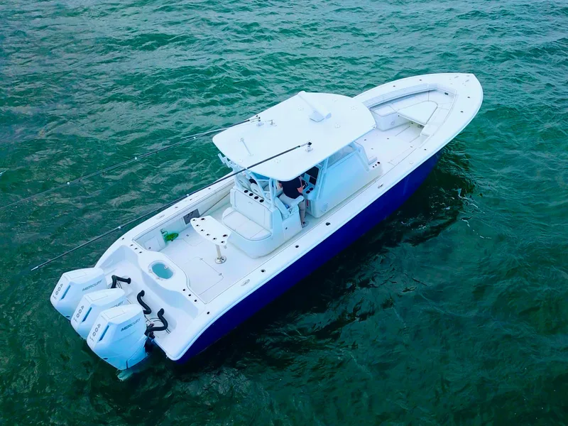 Slide: The Image of 2017 Yellowfin 39 Offshore boat on clear water, featuring dual outboard engines. - 6