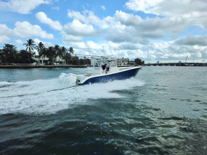 Slide: The Image of 2017 Yellowfin 39 Offshore boat cruising on a scenic waterway under a partly cloudy sky. - 8