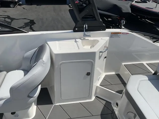 Slide: The Image of 2025 Bayliner D22 boat interior with sink and seating area. - 10