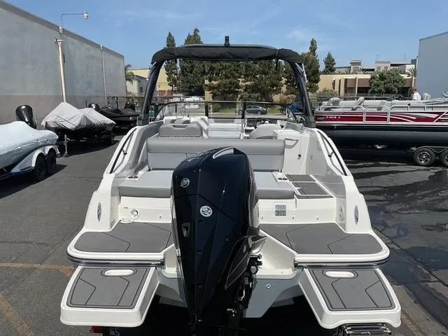 Slide: The Image of 2025 Bayliner D22 boat with outboard motor, parked in a marina lot. - 16