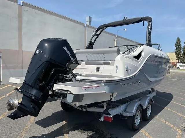 Slide: The Image of 2025 Bayliner D22 boat on trailer with Mercury outboard motor in parking lot. - 3