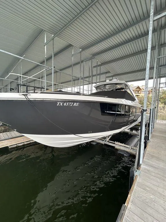 Slide: The Image of 2023 Monterey 378SS boat docked under a metal canopy. - 1