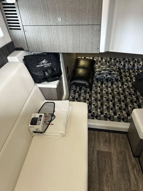 Slide: The Image of 2023 Monterey 378SS interior with modern seating, geometric bedding, and sleek design elements. - 13