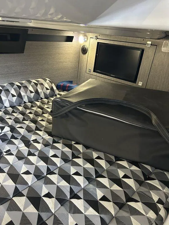 Slide: The Image of 2023 Monterey 378SS cabin interior with geometric-patterned bedding and wall-mounted TV. - 16