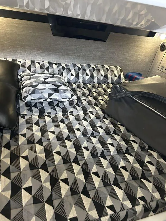 Slide: The Image of 2023 Monterey 378SS interior with geometric-patterned bedding and modern design elements. - 17