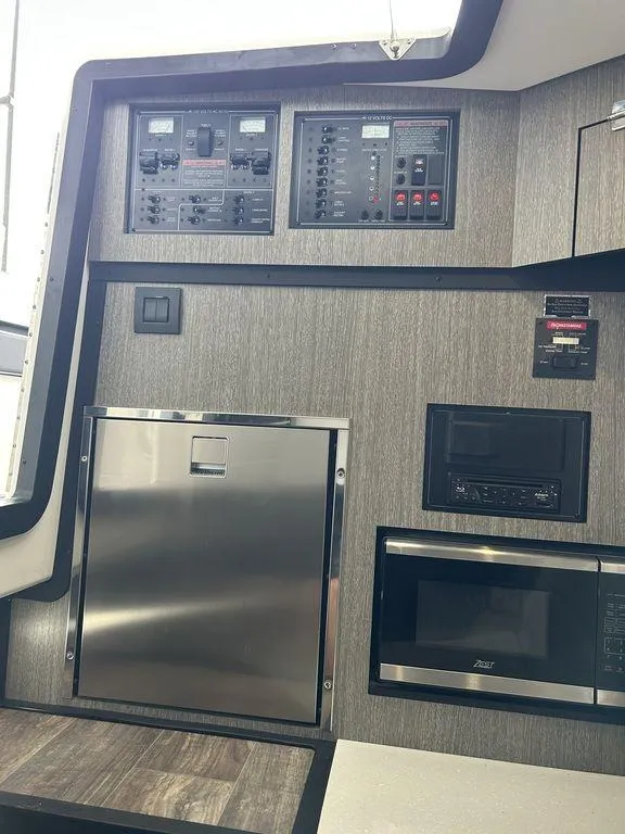 Slide: The Image of 2023 Monterey 378SS interior with control panels and modern appliances. - 19