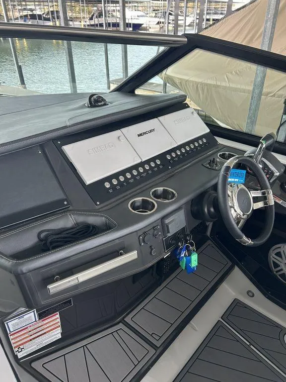 Slide: The Image of 2023 Monterey 378SS boat dashboard with modern controls and steering wheel, docked by the water. - 37
