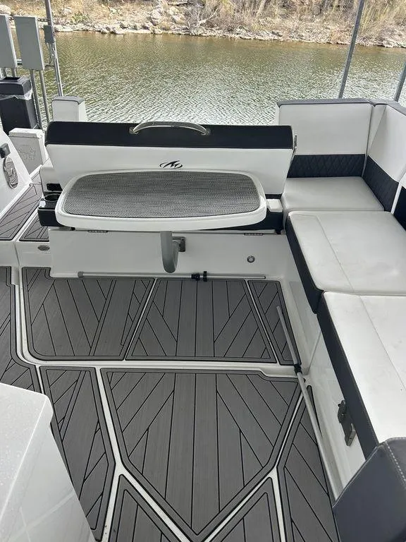 Slide: The Image of 2023 Monterey 378SS boat interior with sleek seating and modern design on a calm lake. - 41