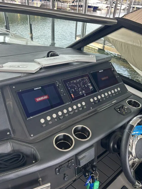 Slide: The Image of 2023 Monterey 378SS boat dashboard with advanced navigation displays and controls. - 47